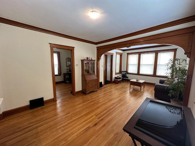 exercise area with crown molding and hardwood / wood-style flooring