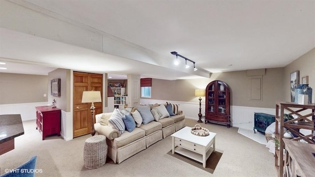 living room with light colored carpet and rail lighting