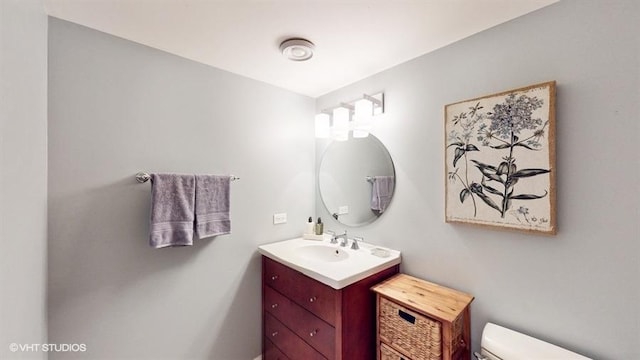 bathroom featuring vanity and toilet