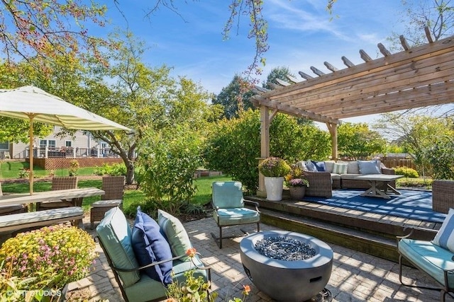 view of patio / terrace with a pergola and an outdoor living space with a fire pit