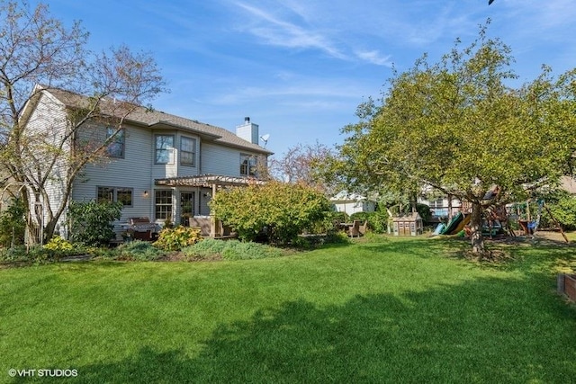 view of yard with a pergola and a playground