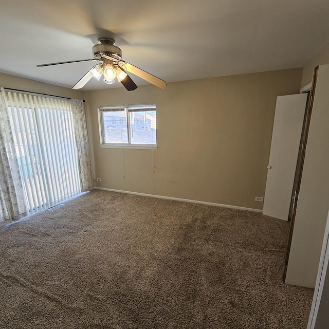 unfurnished room featuring ceiling fan and carpet