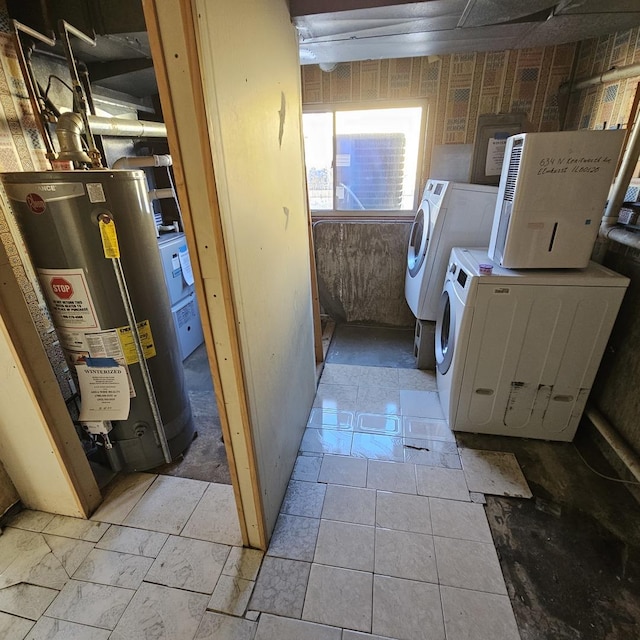 laundry room featuring washing machine and dryer and gas water heater