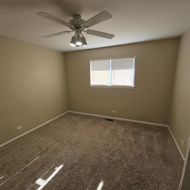 spare room with ceiling fan and carpet flooring