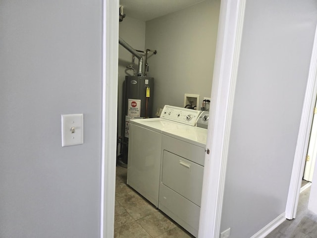 laundry room featuring water heater and washer and clothes dryer