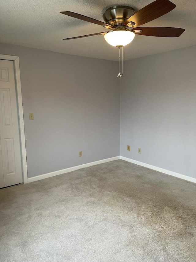 carpeted empty room with a textured ceiling and ceiling fan