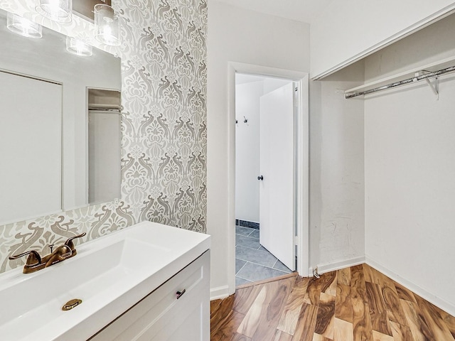 bathroom featuring tasteful backsplash, wood-type flooring, and vanity