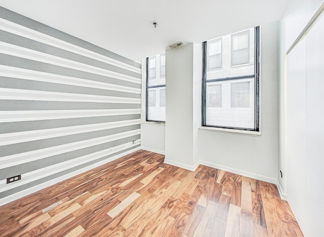 spare room with hardwood / wood-style flooring