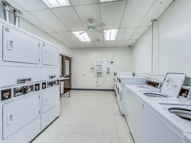 clothes washing area featuring stacked washer and dryer, washing machine and clothes dryer, and ceiling fan