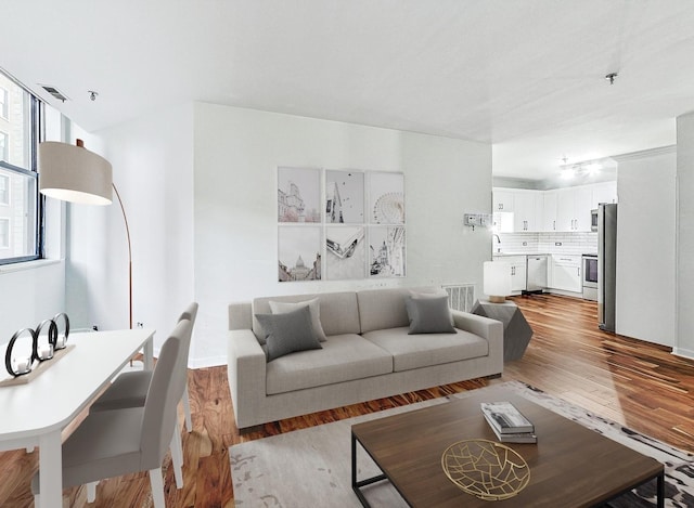 living room featuring sink and light wood-type flooring