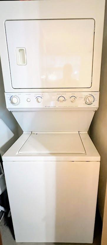 washroom with stacked washer / dryer