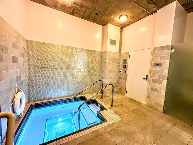 view of swimming pool with an indoor in ground hot tub