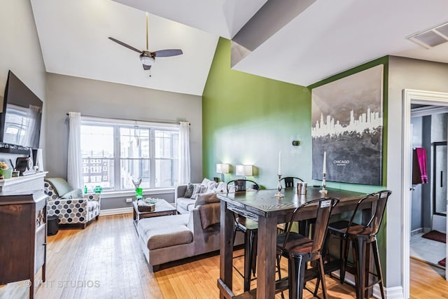 dining room featuring vaulted ceiling, light hardwood / wood-style floors, and ceiling fan