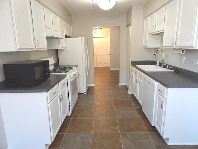 kitchen featuring sink, white appliances, and white cabinetry