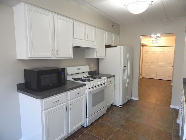 kitchen featuring white cabinets and white appliances