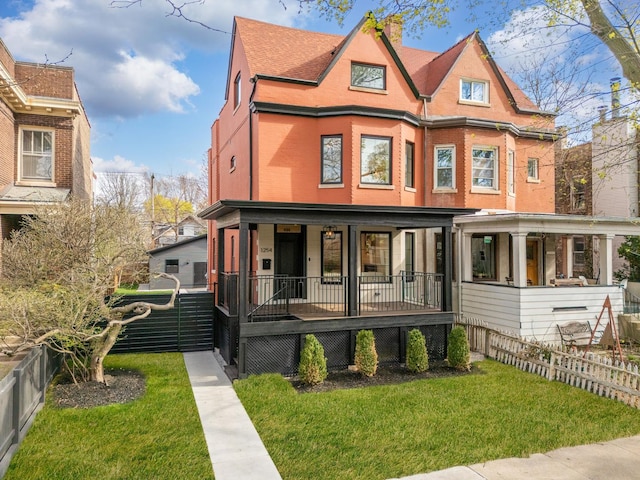 1254 W Norwood St, Chicago, IL 60660 - victorian-style house with fence, covered porch, a front yard, and brick siding