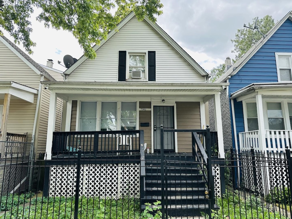 bungalow-style house featuring covered porch and cooling unit