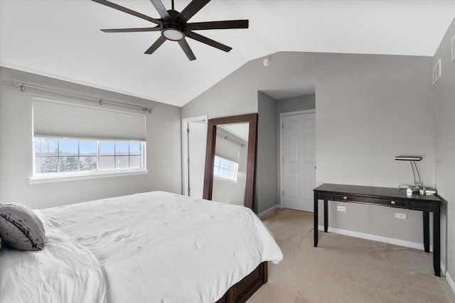 bedroom with ceiling fan, vaulted ceiling, and light carpet