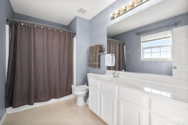 bathroom with tile patterned flooring, vanity, walk in shower, and toilet