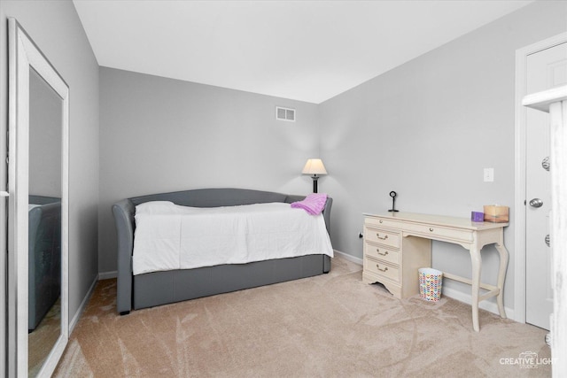 bedroom featuring light carpet