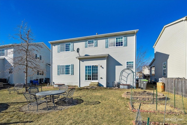 rear view of house with a yard