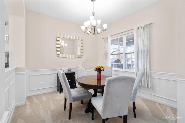 carpeted dining space featuring a chandelier