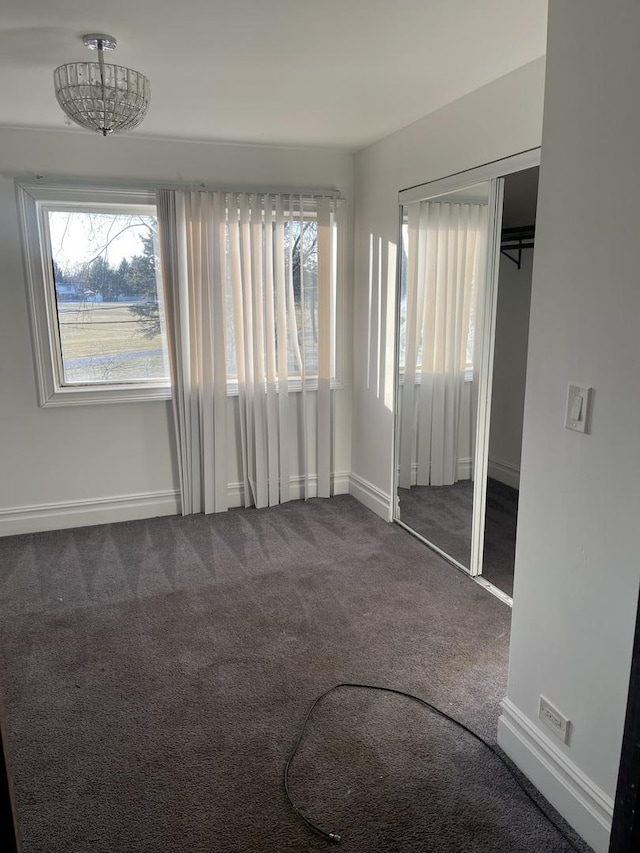 unfurnished bedroom featuring carpet and a closet