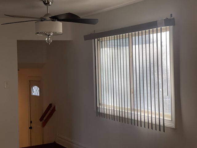 interior space with ceiling fan