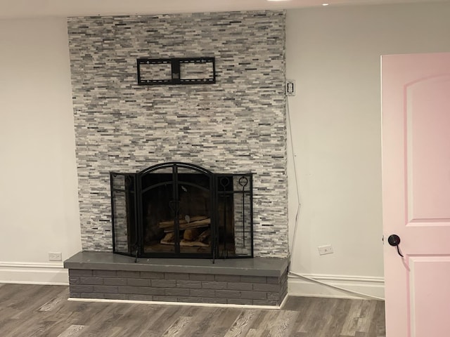 details with wood-type flooring and a fireplace