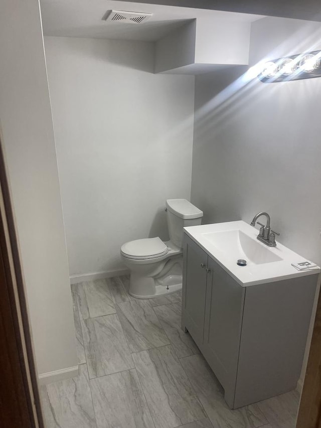 bathroom with toilet and vanity