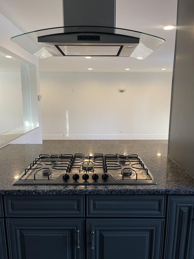 room details featuring island range hood and black gas cooktop