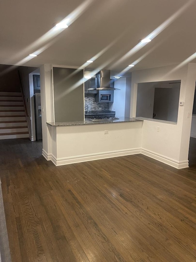 unfurnished living room with dark hardwood / wood-style flooring