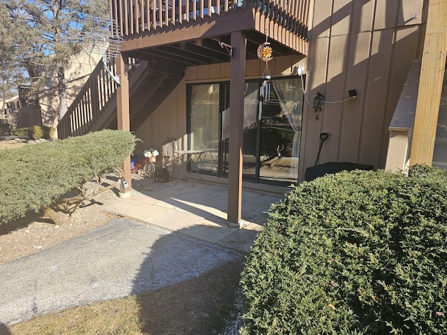 view of exterior entry with a patio