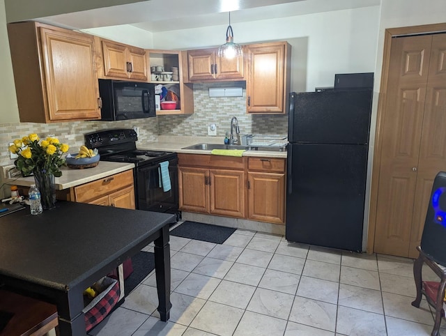 kitchen with black appliances, decorative backsplash, sink, hanging light fixtures, and light tile patterned flooring