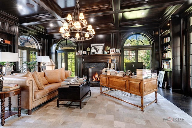 home office with coffered ceiling, a high end fireplace, plenty of natural light, and ornamental molding