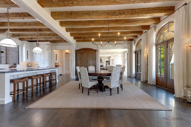 dining room featuring dark hardwood / wood-style flooring, beamed ceiling, and a chandelier