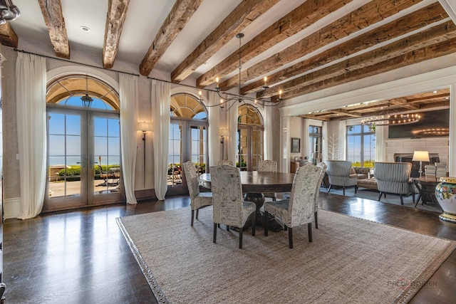 dining space featuring beamed ceiling and french doors