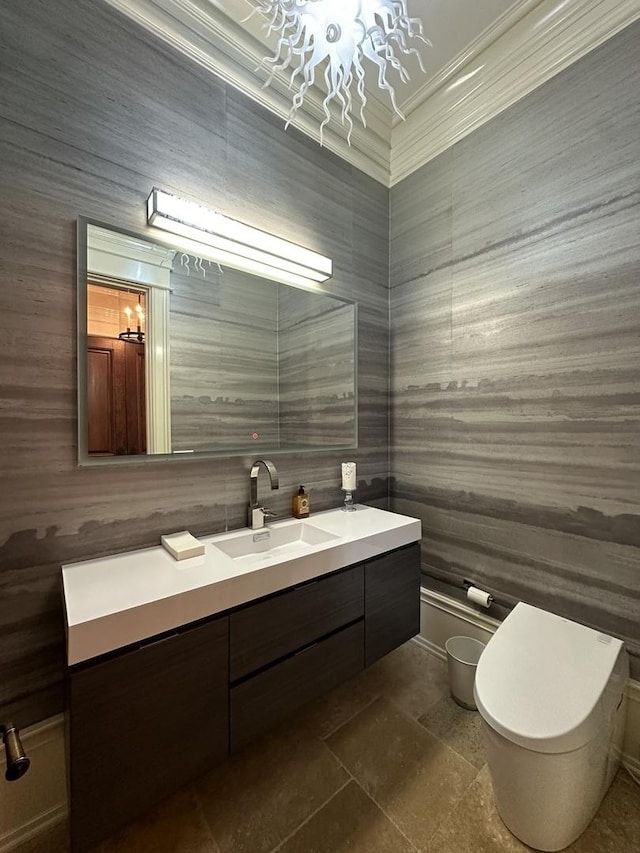 bathroom with vanity, ornamental molding, and toilet