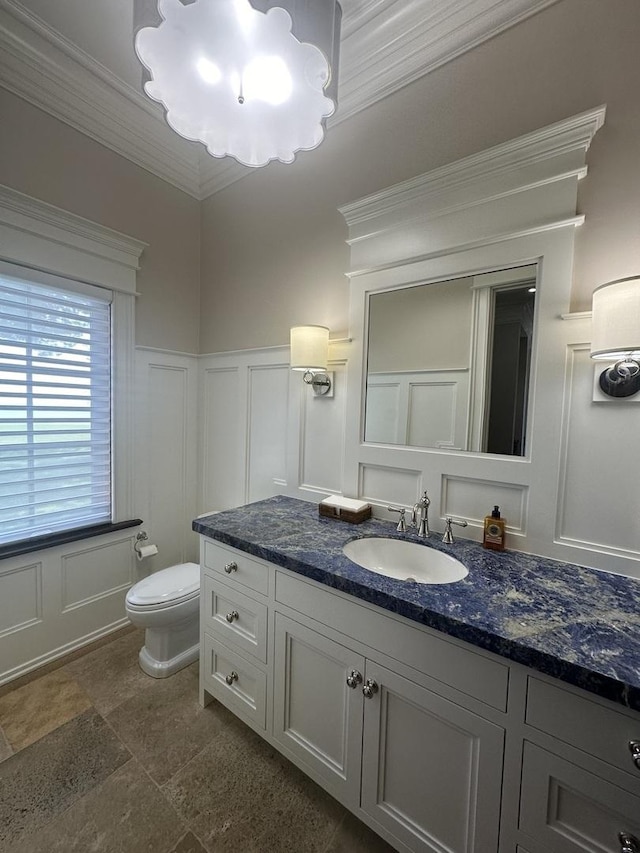 bathroom with crown molding, vanity, and toilet