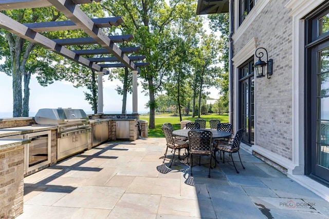 view of patio / terrace with area for grilling and a pergola