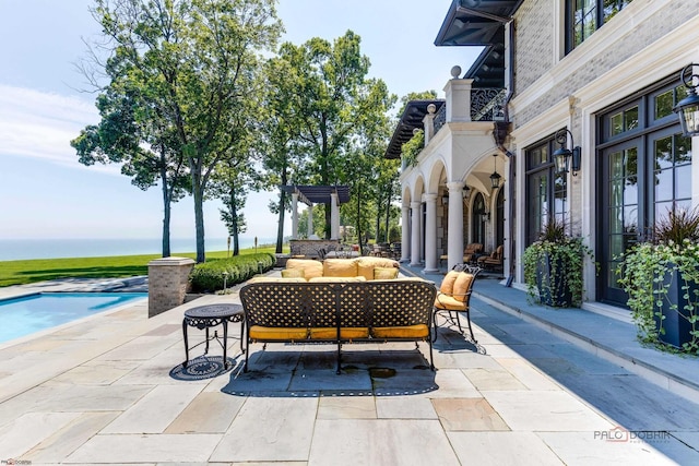 view of patio with a water view, outdoor lounge area, and a pergola