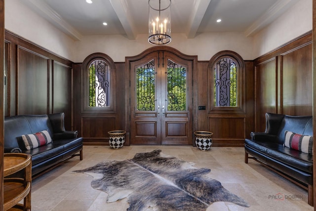 sitting room featuring an inviting chandelier, wooden walls, french doors, and beamed ceiling