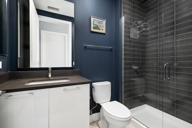 bathroom with walk in shower, vanity, and toilet