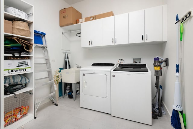 laundry area featuring cabinets and washing machine and clothes dryer