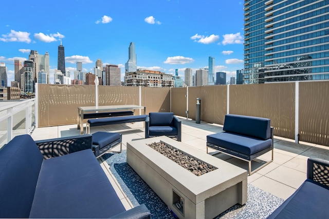 view of patio featuring an outdoor living space with a fire pit