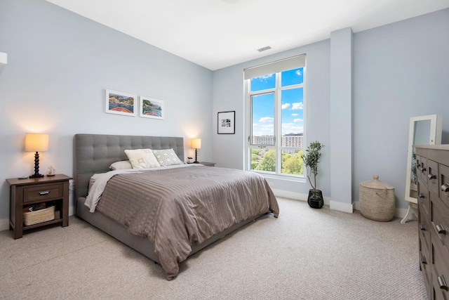 bedroom with light colored carpet