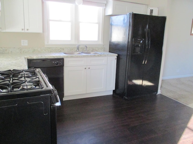 kitchen with sink, white cabinets, and black appliances