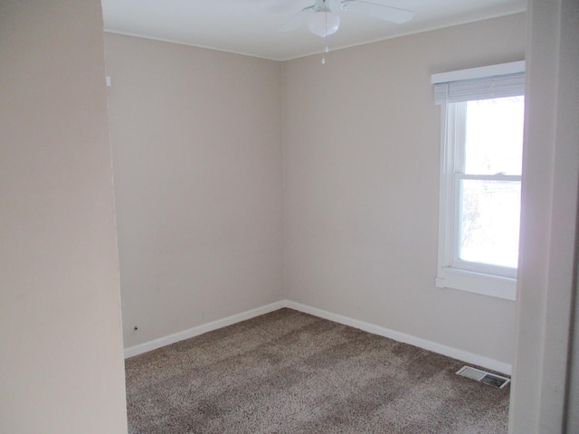 empty room featuring ceiling fan and carpet floors