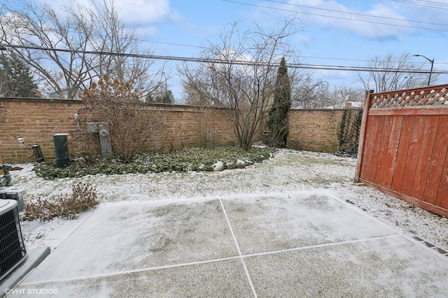 yard layered in snow with central air condition unit