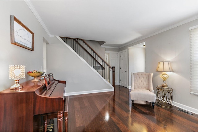 living area with dark wood-type flooring and ornamental molding